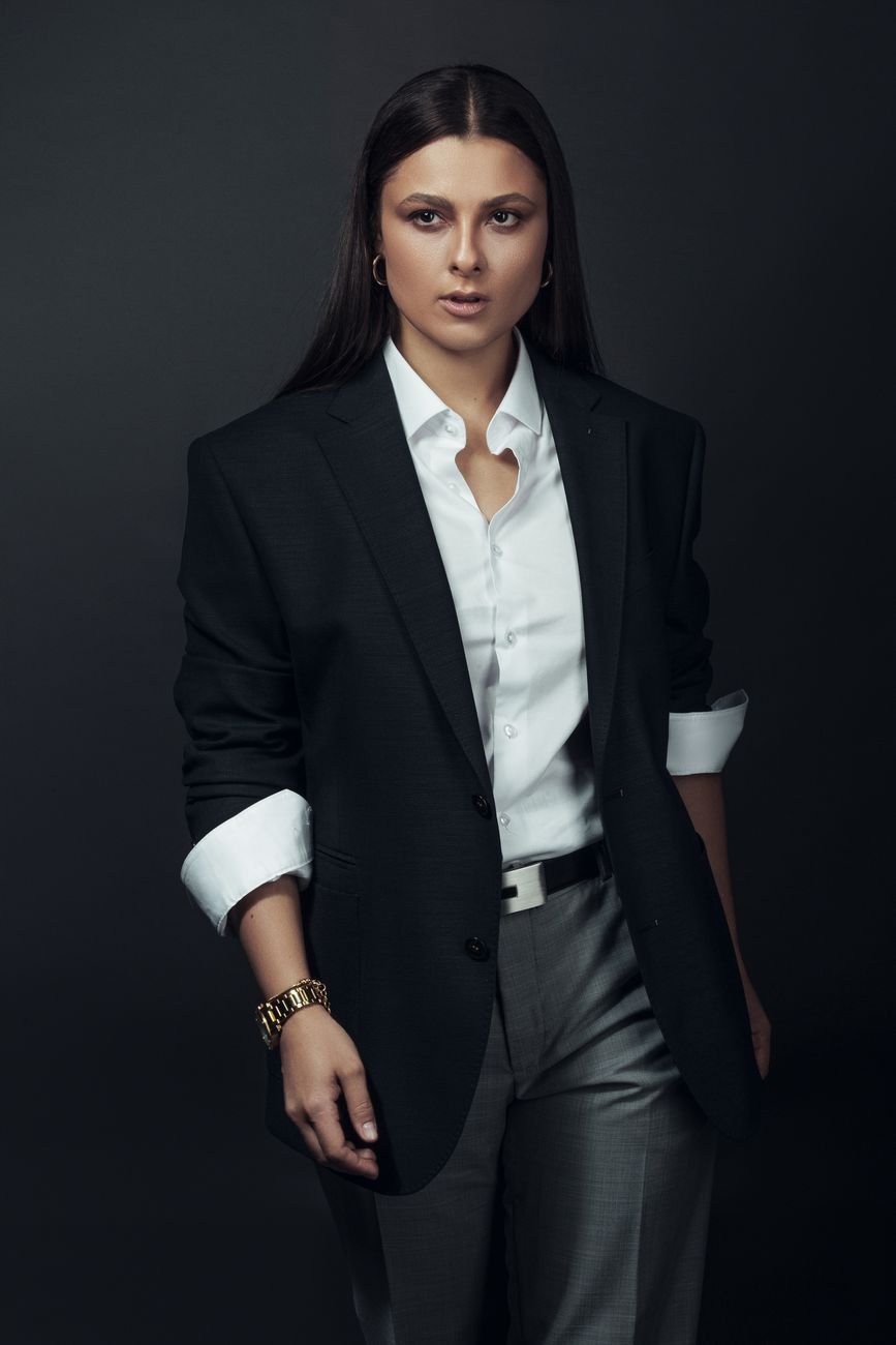 Sophisticated portrait of a woman in a blazer, exuding confidence and professionalism.